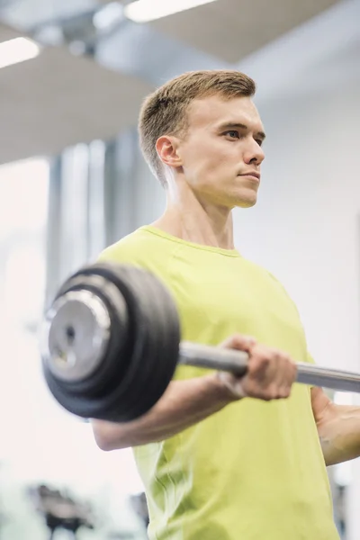 Man doing exercise with barbell in gym — Stock Photo, Image