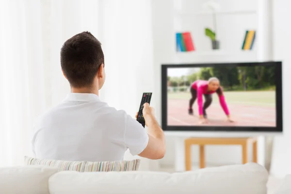 Man watching sport channel on tv at home — Stock Fotó