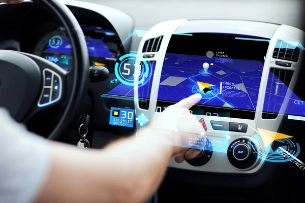 Male hand using navigation system on car dashboard — 图库照片