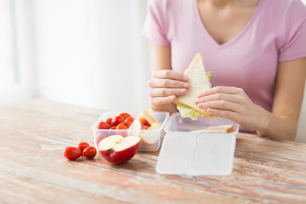 Close up of woman with food in plastic container — Stock Photo, Image