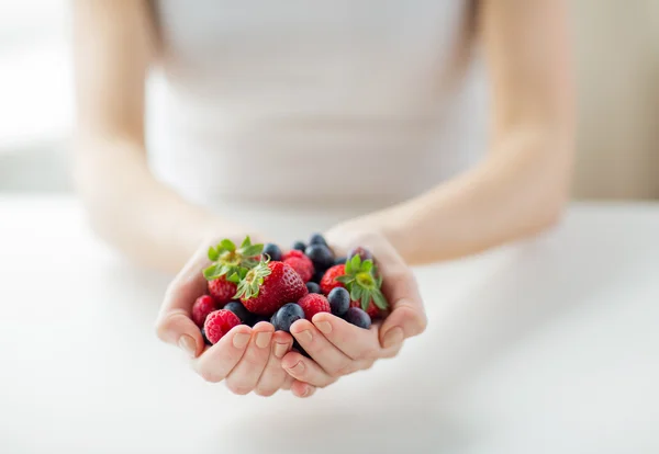 Close up of woman hands holding berries — Stock Photo, Image
