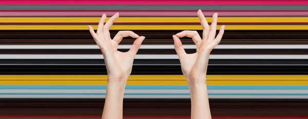 Woman hands showing ok sign over blue sky — Stock fotografie