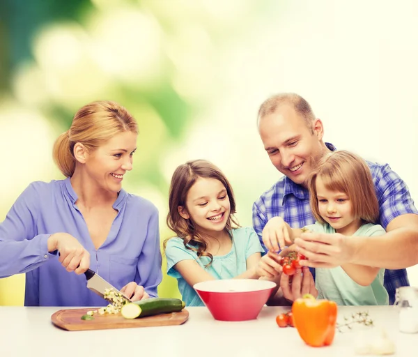 Familia feliz con dos niños haciendo la cena en casa — Foto de Stock