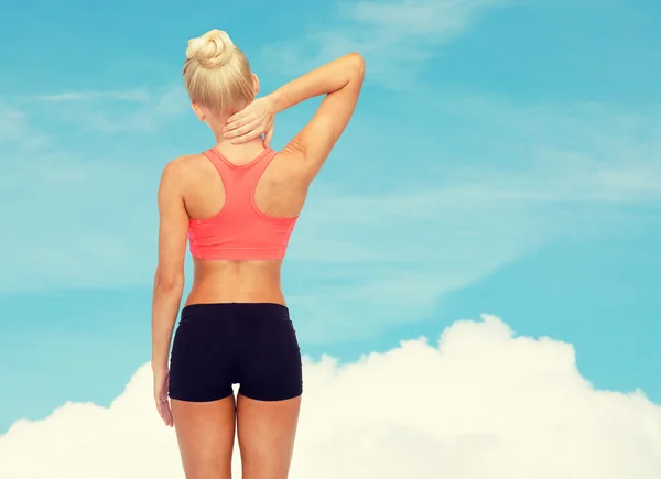 Sporty woman touching her neck — Stock Photo, Image