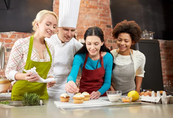 happy women and chef cook baking in kitchen