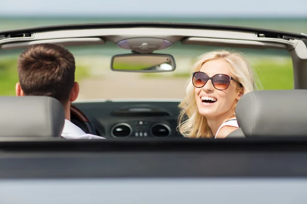 Happy man and woman driving in cabriolet car — Stock Photo, Image