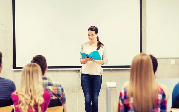Group of smiling students in classroom — Stock Photo, Image