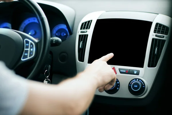 Male hand pointing finger to monitor on car panel — Stock Photo, Image
