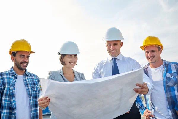 Group of builders and architects with blueprint — Stock Photo, Image