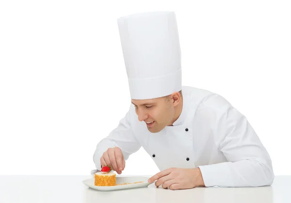 Happy male chef cook decorating dessert — Stock Photo, Image