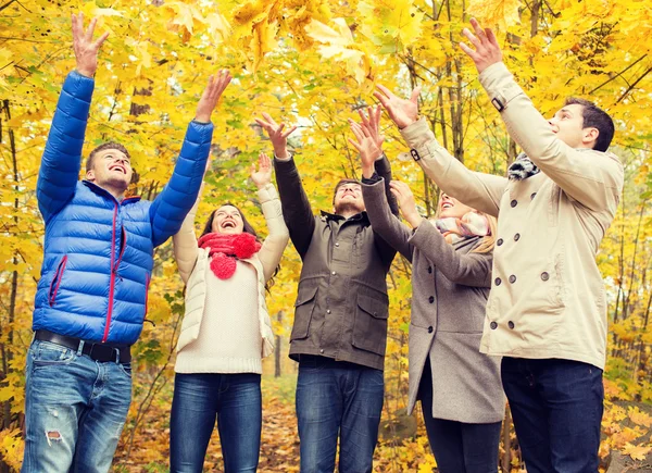 Gruppo di uomini e donne sorridenti nel parco autunnale — Foto Stock