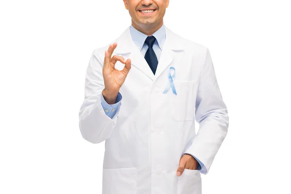 Happy doctor with prostate cancer awareness ribbon — Stock Photo, Image