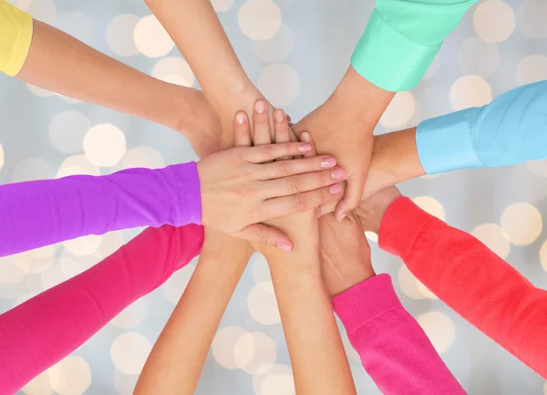 Close up of women hands on top in rainbow clothes — Stock Photo, Image