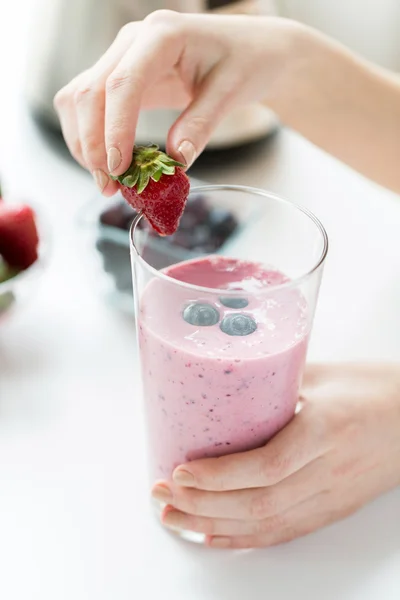 Close up of woman with milkshake and strawberry — Stock Photo, Image