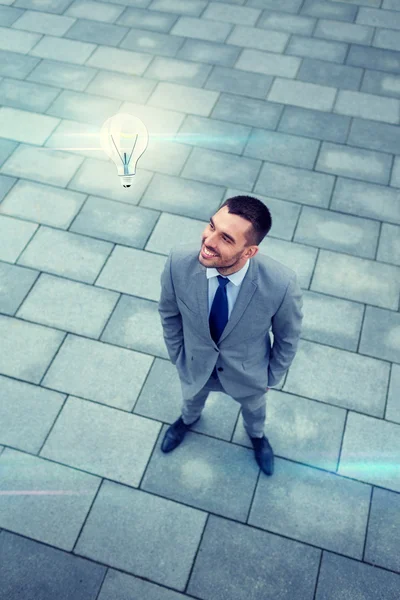 Young smiling businessman outdoors from top — Stock Photo, Image