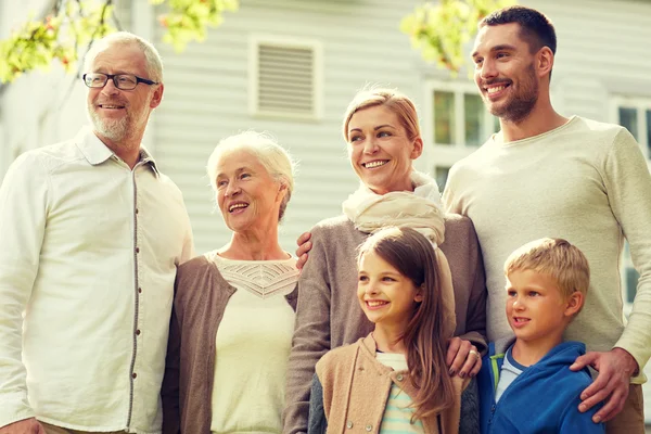 Happy family in front of house outdoors — Stock Photo, Image