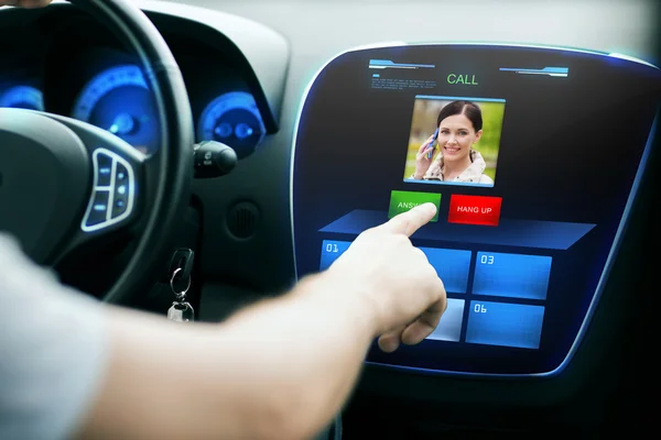 Male hand receiving video call on car panel screen — ストック写真