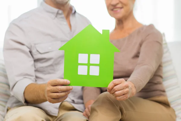 Close up of happy senior couple with green house — Stockfoto