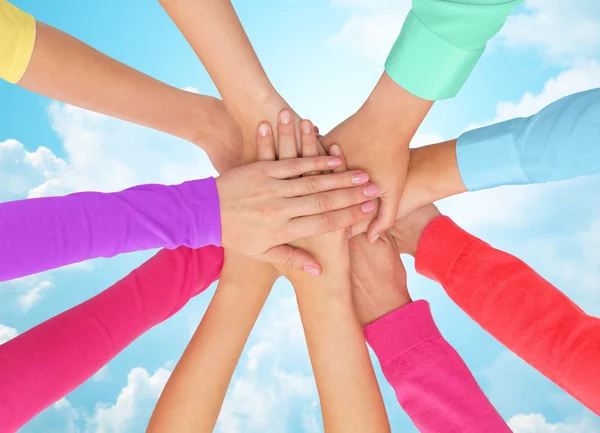 Close up of women hands on top in rainbow clothes — Stock Photo, Image