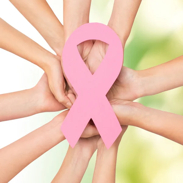 Close up of hands with cancer awareness symbol — Stock Photo, Image