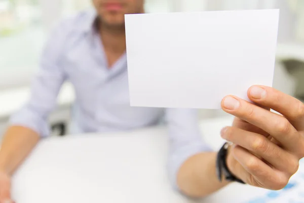 Close up of businessman with blank paper at office — Stock Photo, Image