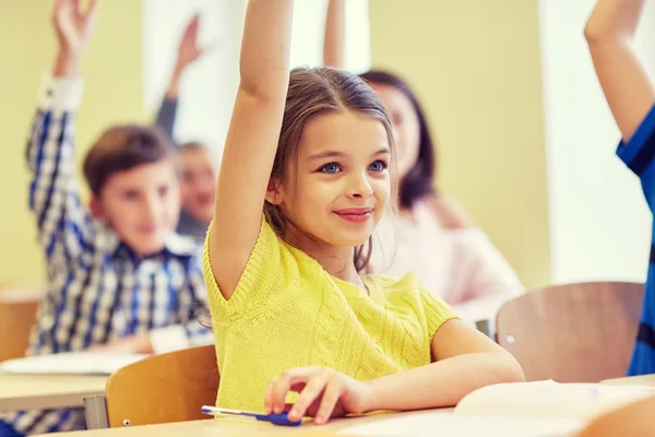 Group of school kids with notebooks in classroom — Stock Photo, Image