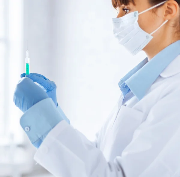 Female doctor holding syringe with injection — Stock Photo, Image