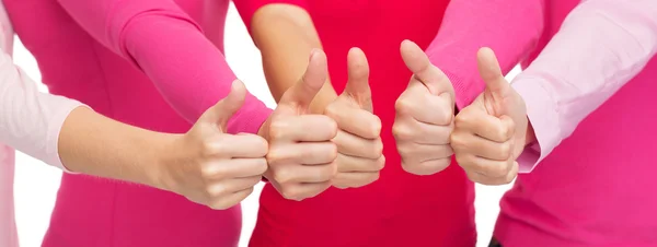親指に現れるピンクのシャツの女性のクローズ アップ — ストック写真