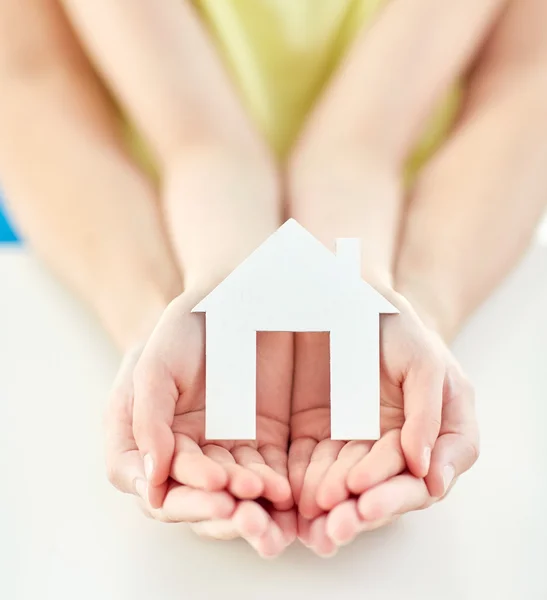 Close up of woman and girl hands with paper house — Stock Photo, Image