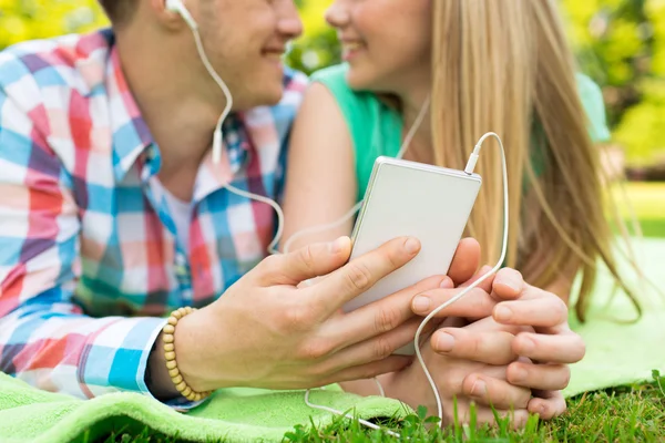 Close up of couple with smartphone and earphones — 스톡 사진