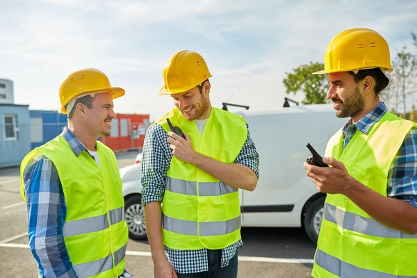 Happy male builders in vests with walkie talkie — Stock Photo, Image