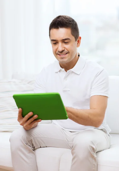 Glimlachende man aan het werk met tablet pc thuis — Stockfoto