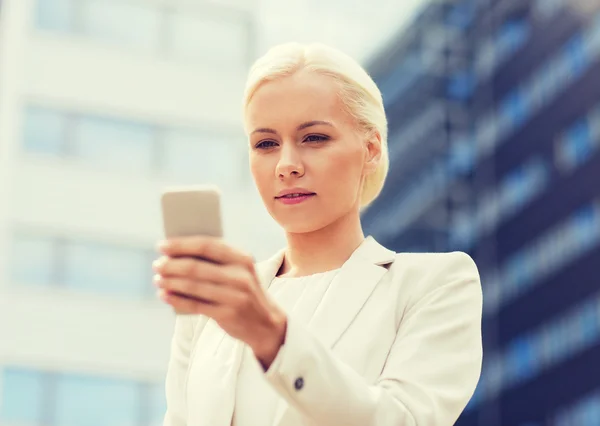 Серйозна бізнес-леді зі смартфоном на відкритому повітрі — стокове фото