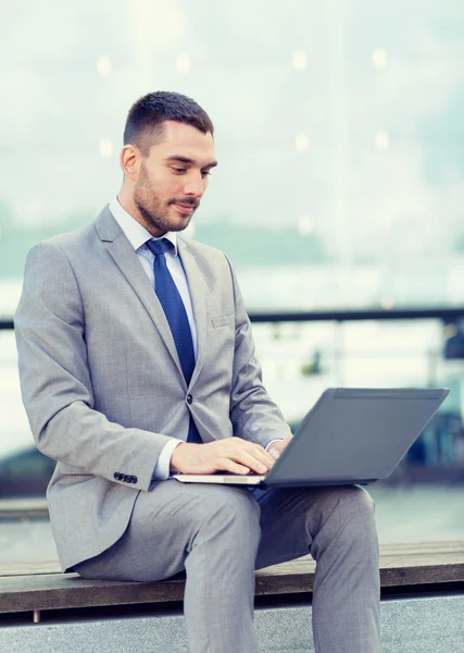 Businessman working with laptop outdoors — Stock Photo, Image