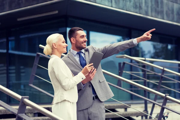 Smiling businessmen with tablet pc outdoors — Stock Photo, Image