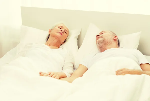 Happy senior coupler lying in bad at home — Stock Photo, Image