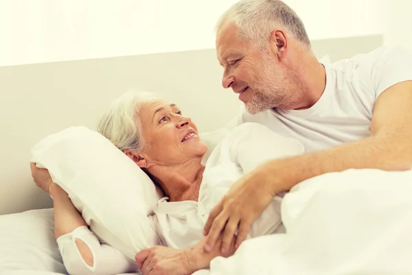 Happy senior coupler lying in bad at home — Stock Photo, Image