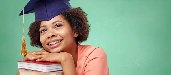 Happy african bachelor girl with books at school — 图库照片