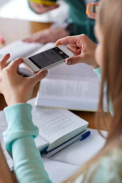 Manos de los estudiantes con el teléfono inteligente haciendo hoja de trucos —  Fotos de Stock