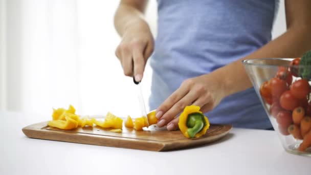 Close up of young woman chopping pepper at home — Stock Video