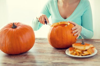 close up of woman with pumpkins at home clipart
