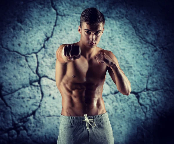Young man in fighting or boxing position — Stock Photo, Image