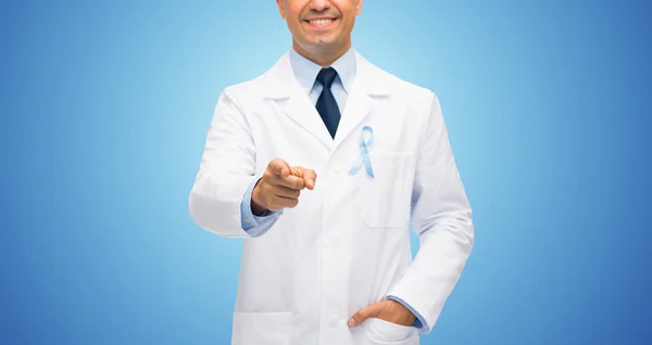 Happy doctor with prostate cancer awareness ribbon — Stock Photo, Image