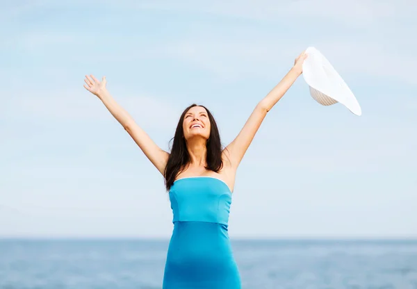 Girl with hands up on the beach — Stock Photo, Image