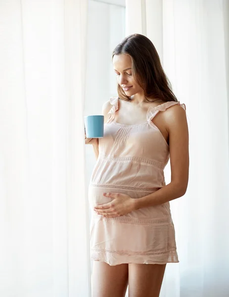 Mujer embarazada feliz con taza de té en casa — Foto de Stock