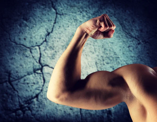 Close up of young man flexing and showing biceps Royalty Free Stock Images