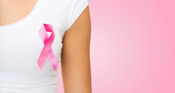 Close up of woman with cancer awareness ribbon — Stock Photo, Image