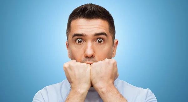 Scared man face over blue background — Stock Fotó