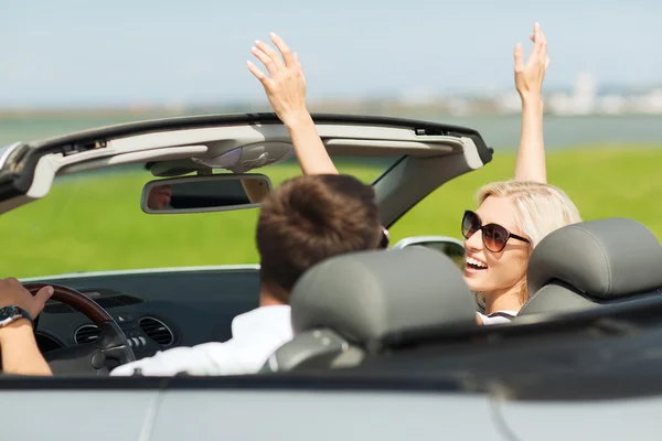 Happy man and woman driving in cabriolet car — Stock Photo, Image