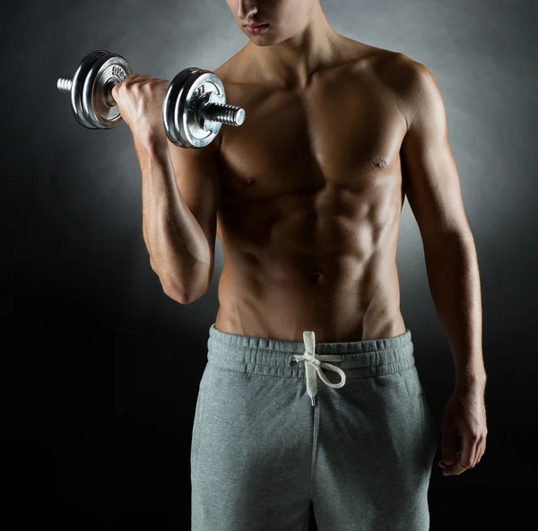 Young man with dumbbell — Stock Photo, Image